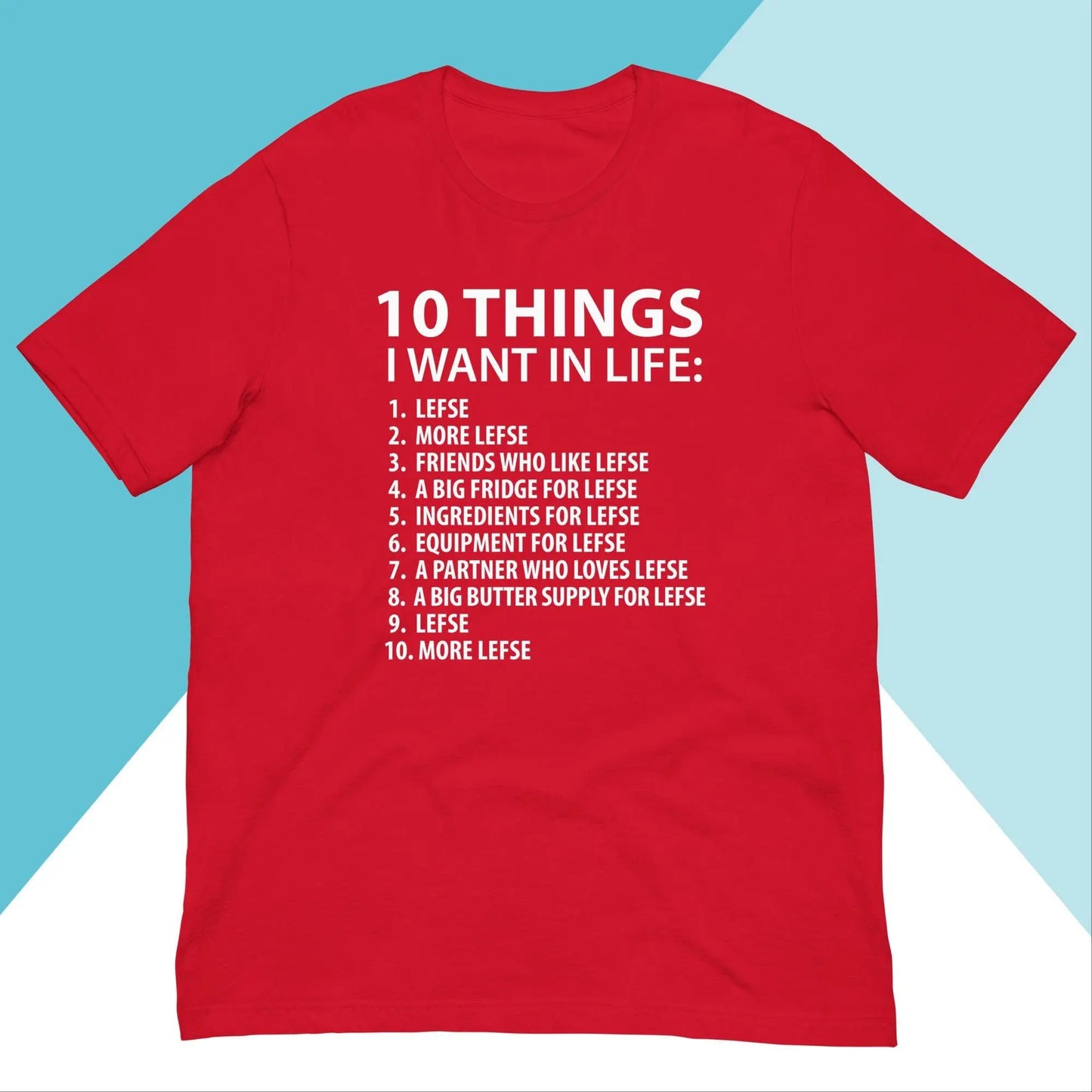 The North Owl Apparel 10 Things I Want In Life Lefse Unisex Shirt features a relaxing fit with humorous white text on a red backdrop, listing all things Lefse. A stylish blue and white geometric pattern complements its ultimate comfort and playful appeal.