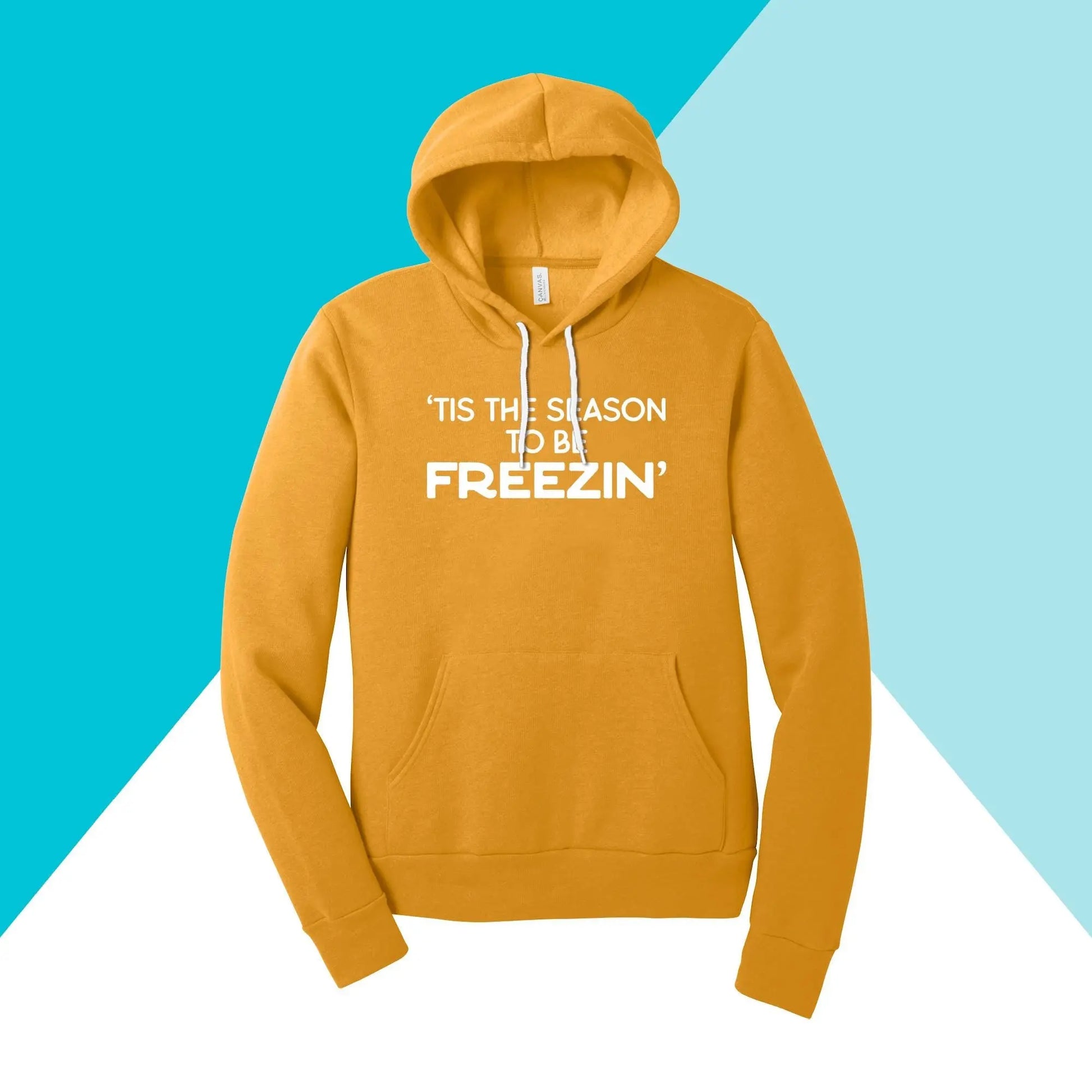 The North Owl Apparel unisex hoodie, Tis the Season to be Freezin, features a comfy yellow fabric with a blue and white geometric design, ideal for cozy winter days.