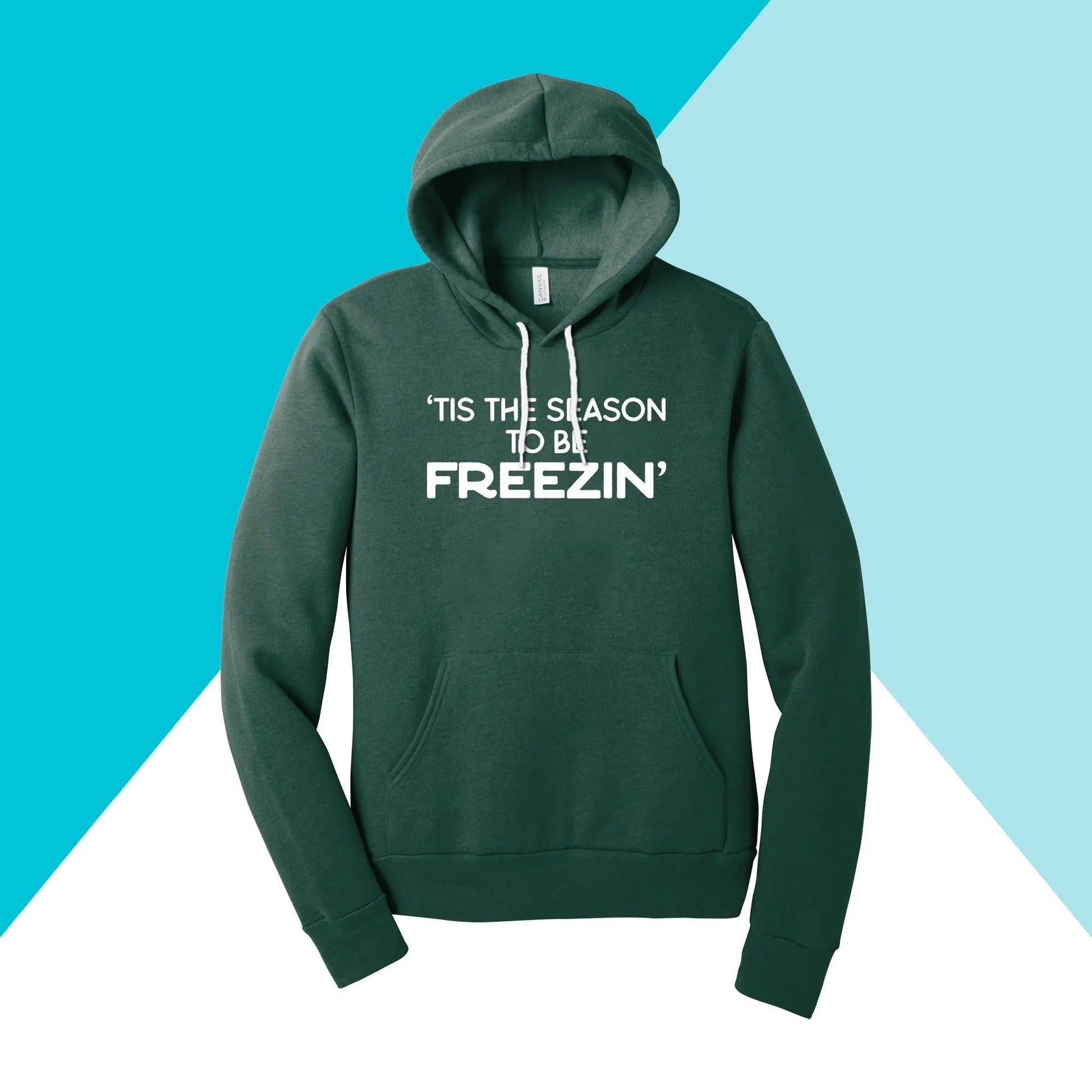 The Tis the Season to be Freezin unisex hoodie by North Owl Apparel features a green background with a geometric design of teal and white triangles and has TIS THE SEASON TO BE FREEZIN printed in white, perfect for cozy winter wear.